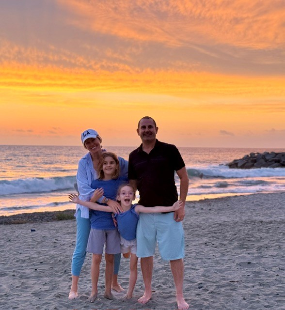 Brad Sivert with his family at the beach at sunset